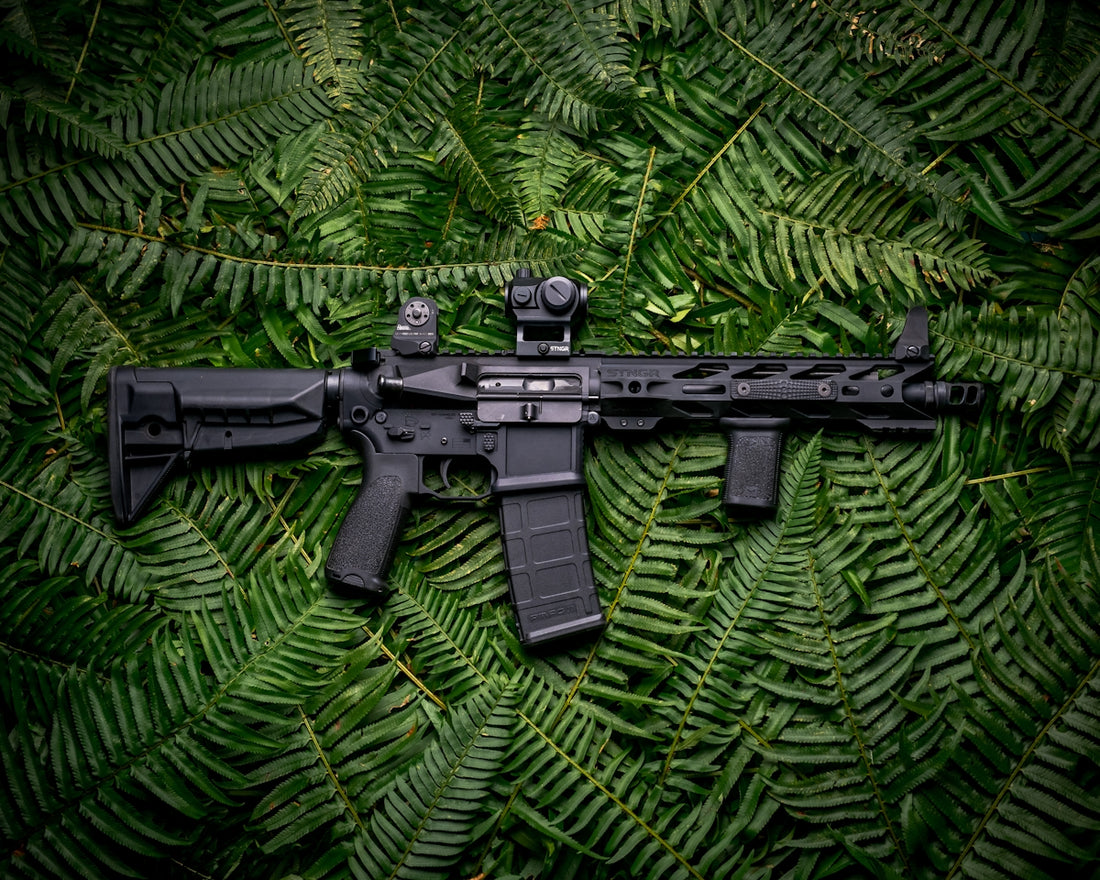 black rifle on green textile